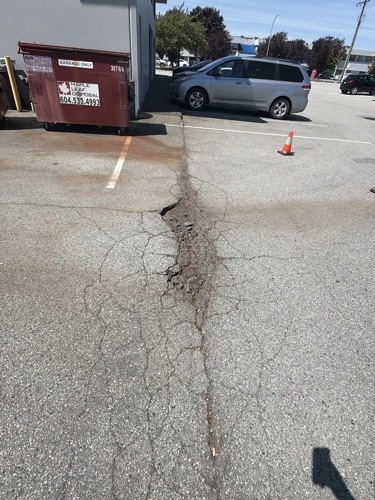 Cracked and failing asphalt parking lot before repair